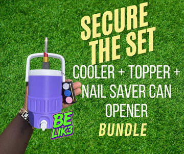 May include: A purple beverage cooler with a white handle and lid, featuring a metallic topper and a small black nail saver can opener attached by a chain. The text SECURE THE SET COOLER + TOPPER + NAIL SAVER CAN OPENER BUNDLE and BE LIK3 are visible.